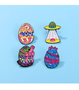 Detailed enamel pins set featuring cartoon dinosaur egg and Happy Easter motifs