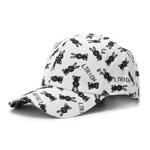 Close-up of white cotton baseball cap featuring black rabbit print and LTRICH text detail
