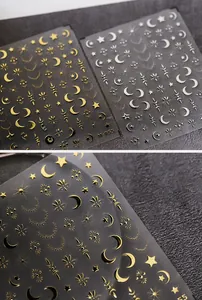 Detailed view of gold and silver moon and star nail stickers with metallic finish