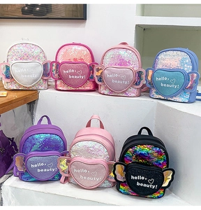 Detail view of colorful sequin mini backpacks with heart pockets and transparent wings