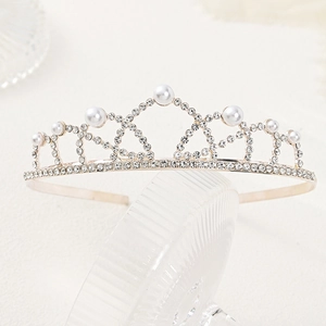 Macro shot of a bridal crown headpiece with white pearls and sparkling rhinestones