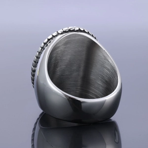 Detail of silver stainless steel ring showing inner brushed metal texture and grainy edges