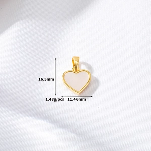 Macro view of 14K gold-filled heart pendant with white shell inlay, size 16.5x11.46mm