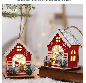 Detail of wooden Christmas house ornaments with LED lights and festive deer decorations