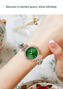 Elegant rose gold quartz watch with a green sunray dial and gemstone-inlaid bracelet band