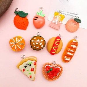 Detailed flat lay of miniature food resin pendants including pizza, burgers, and fruits