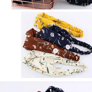 Detail of floral chiffon headbands with side buttons in multiple colors and soft patterns