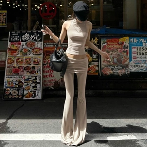 Close-up of sleeveless halter crop top and low-rise flared trousers in beige