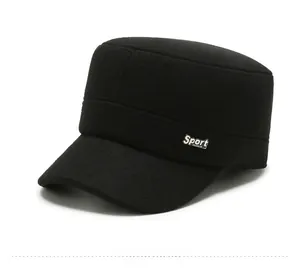 Detail view of black flat top military cap with silver Sport metal badge and stitching