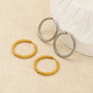 Minimalist textured hoop earrings in gold and silver finish with braided pattern