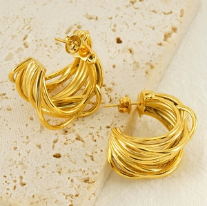 Detailed view of 18K gold-plated C-shape multi-layer winding earrings on stone surface