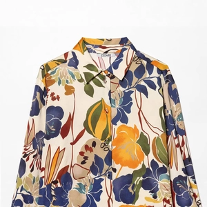 Professional flat lay of a satin long sleeve shirt with colorful retro floral prints