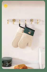 Detail view of silicone kitchen gloves with non-slip texture and hanging loops for storage
