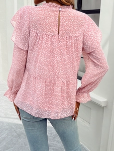 Detail of pink floral leopard print blouse featuring ruffle collar and tiered back hemline