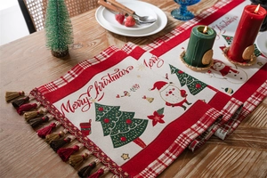 Detailed weave of Christmas table runner with snowman, tassels, and festive patterns