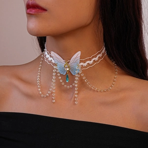 Close-up of butterfly choker featuring white lace, purple wings and crystal tassel fringe