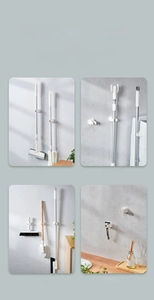 Close-up of a wall-mounted white mop holder rack showing durable grip for home tools