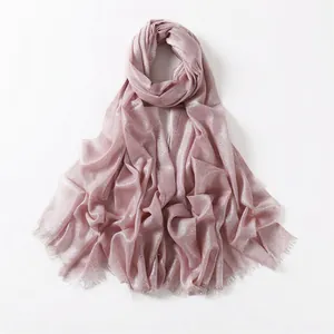 Detail of pink scarf showing metallic lurex shimmer fabric and frayed edge finish