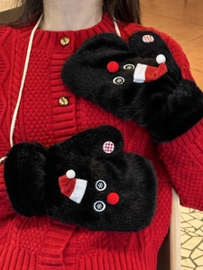 Detail of plush snowman mittens with cute red hat and soft festive knit sweater texture