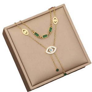 Emerald green butterfly layered necklace in gold finish with eye pendant in beige jewelry box