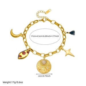 Gold-plated stainless steel sun and moon pendant bracelet with celestial charms on white background