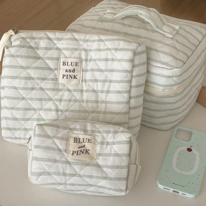 Three-piece quilted travel pouch set with green stripes and Blue and Pink labels