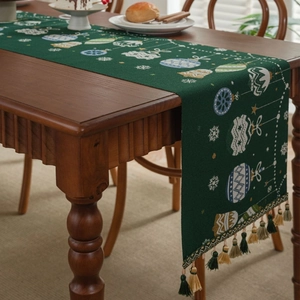 Christmas table runner with green candy jacquard, snowflakes and festive fringe tassels