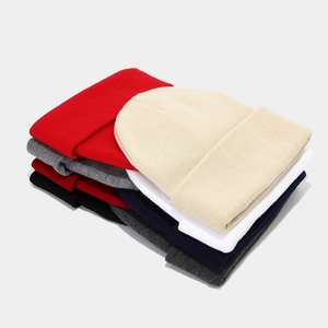 Multiple colors of ribbed knit beanies stacked neatly for winter warmth and style