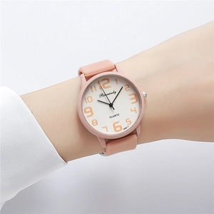 Detailed view of pink silicone watch strap and white dial with orange numeric markers