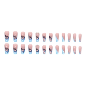 Blue butterfly press-on nails in long coffin shape with rhinestones on white background