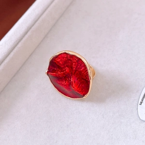 Detailed macro shot of a red enamel ring with vintage gold plated wavy edges