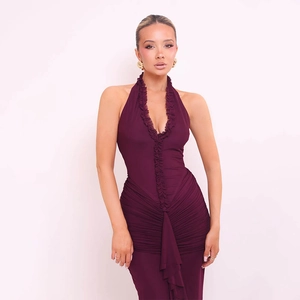 Detailed close-up of ruffle neckline and pleated texture on a wine red halter dress