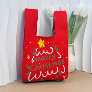 Detail of red Christmas knit tote bag with Merry Christmas text and festive patterns