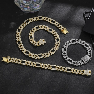 Detailed view of luxury gold and silver iced-out cuban link jewelry set on black background