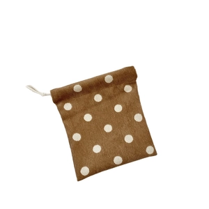 Brown corduroy drawstring storage pouch with white polka dots for makeup and accessories