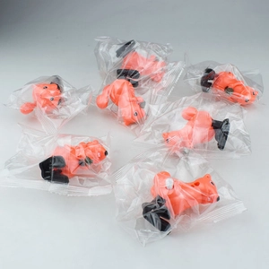 Macro shot of orange clockwork squirrels in individual clear plastic packaging bags
