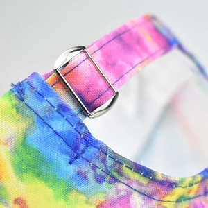 Detailed macro shot of tie-dye canvas baseball cap with silver metal buckle adjustment