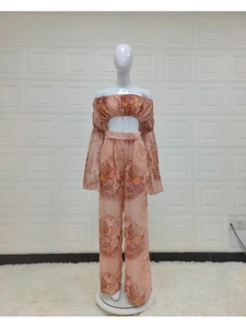 Detail of floral chiffon off-shoulder crop top and high-waisted wide-leg trousers