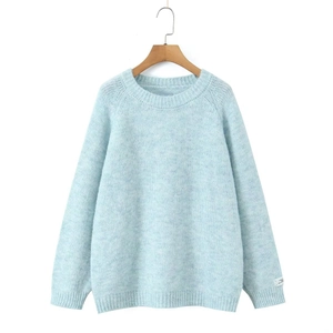Detail of light blue mohair knit sweater showing ribbed cuffs and soft texture