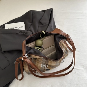 Brown plaid oversized commuter backpack for women showing interior storage capacity