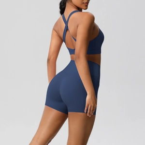 Detail view of navy yoga set featuring cross-back sports bra and high-waisted gym shorts