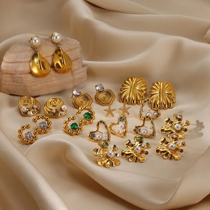 Elegant gold plated stainless steel pearl and zircon earrings collection on silk