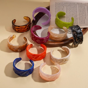 Colorful geometric acrylic bangles with wavy texture in vintage minimalist style