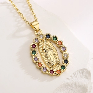 Gold plated Virgin Mary oval pendant necklace with multicolored zircons on stone background