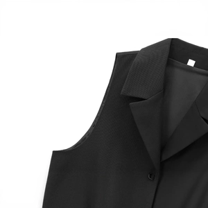 Sleeveless black quilted vest with stand collar and button detail on white background