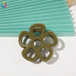 Detailed view of an olive green flower hair claw clip with glossy resin finish