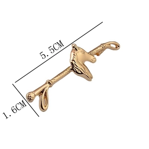 Detailed view of horse head brooch in gold finish with 5.5cm x 1.6cm dimensions