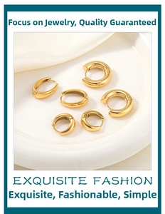 Three pairs of different sized 18k gold plated stainless steel hoop earrings on a tray
