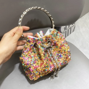 Detail of colorful rhinestones and metal ring handle on a luxury bucket bag