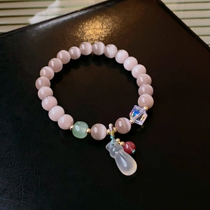 Detail of colorful fluorite crystal beaded bracelet with cat eye stone on black leather